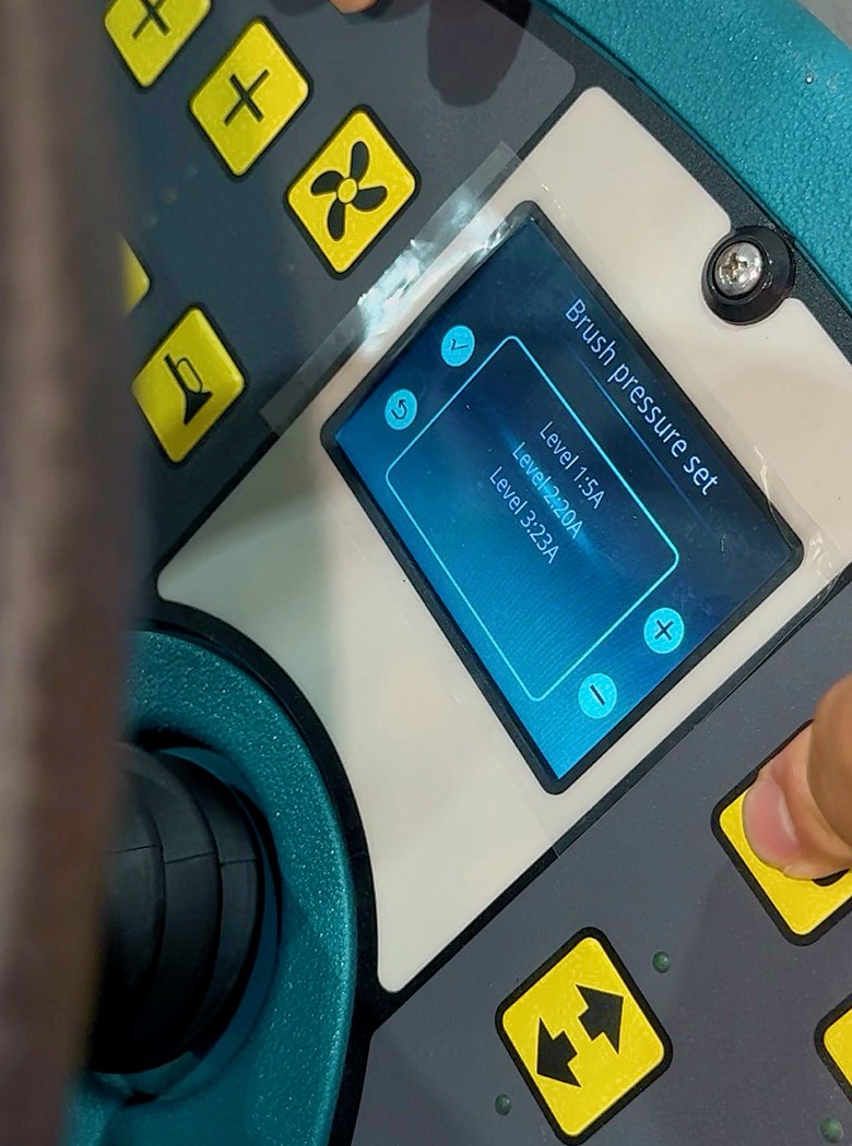Real floor scrubber HMI showing Brush pressure set with Level 1: 5A, Level 2: 20A, Level 3: 23A