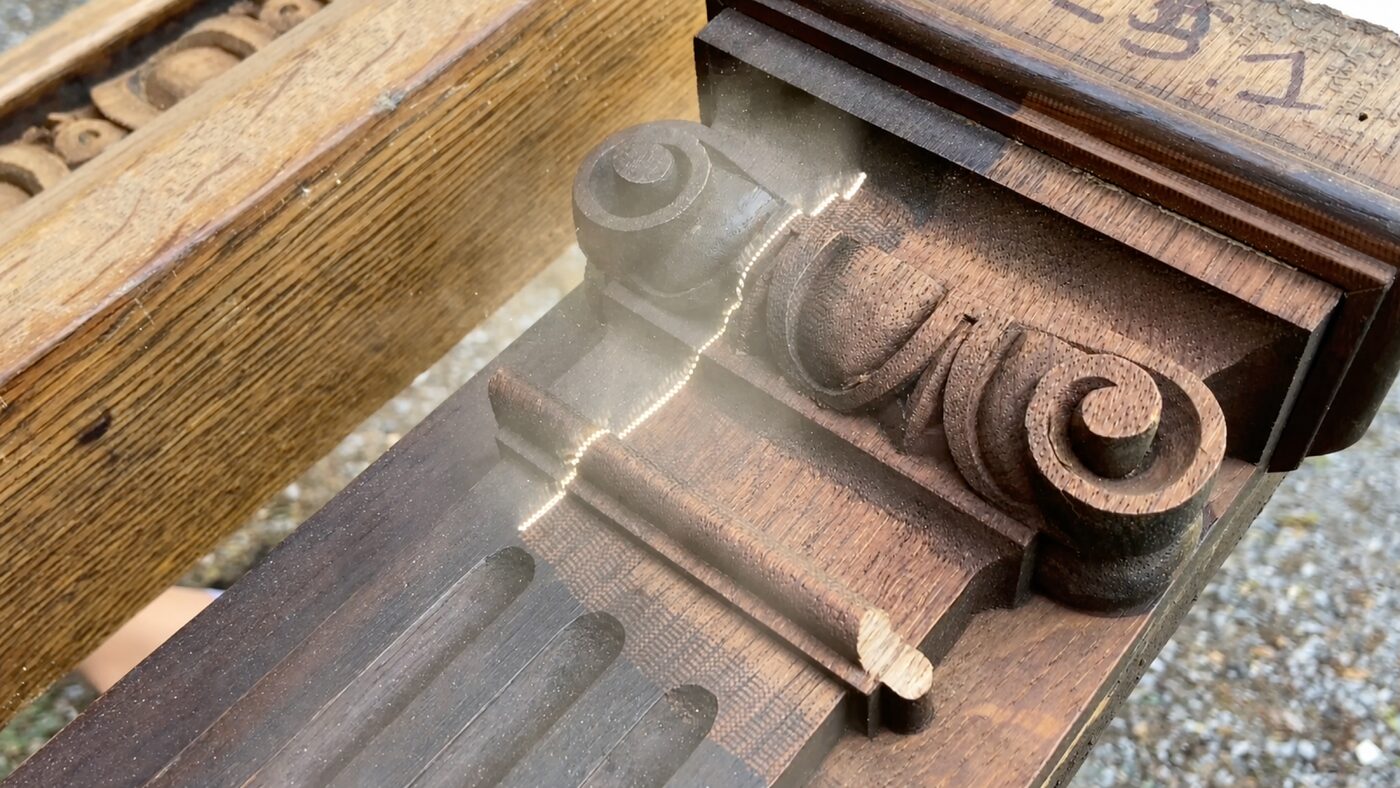 Pulsed laser cleaning machine gently cleaning a carved wooden surface during restoration work